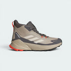 Highlights the high-velocity lines of the seamless overlays, the crisp Terrex branding, and the professional look of the mid-height ankle cuff resting above the charcoal mudguard.
