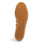 The classic dark gum rubber traction pattern, showcasing the heritage indoor-football design.