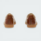 Focusing on the reinforced heel stitching and the clean, handcrafted finish of the Italian workshop.