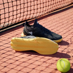 View of the Adiwear clay outsole, showcasing the deep herringbone traction pattern designed for sliding on clay courts.