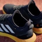 Rear view focusing on the external heel clip and the structured support designed for stability during high-speed play.