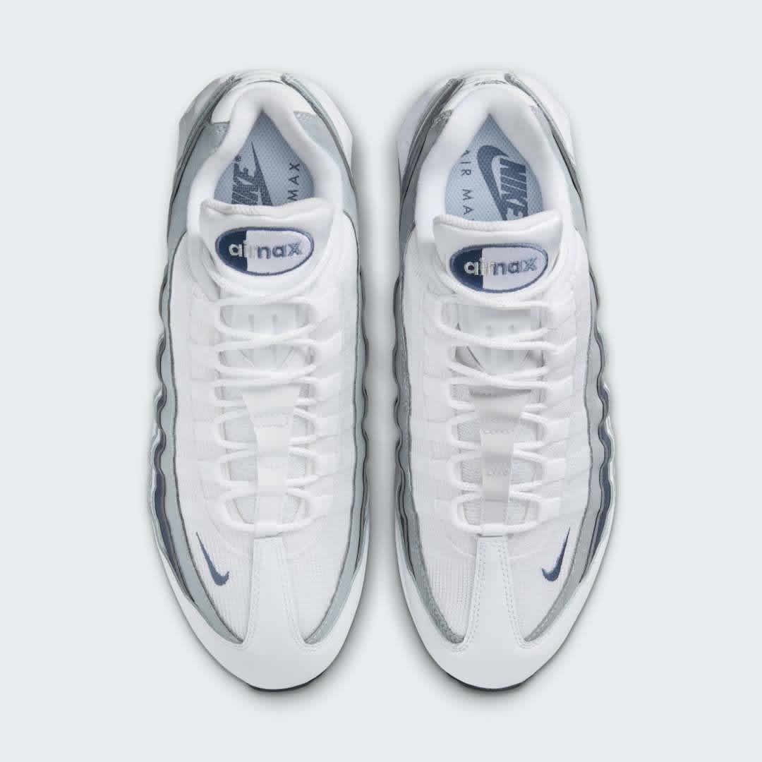 Top-down view of a pair of Nike Air Max 95 OG Men's running shoes in white, highlighting their iconic silhouette and lacing system.