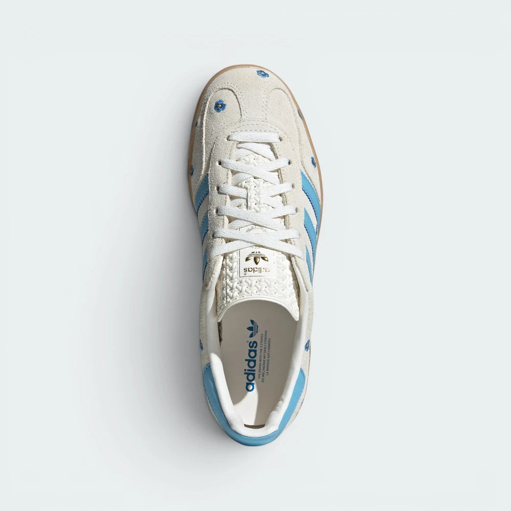 Focuses on the tidy lace closure layout, the clean alignment of the soft light brown suede tongue, and the iconic T-toe panel covering the front box.