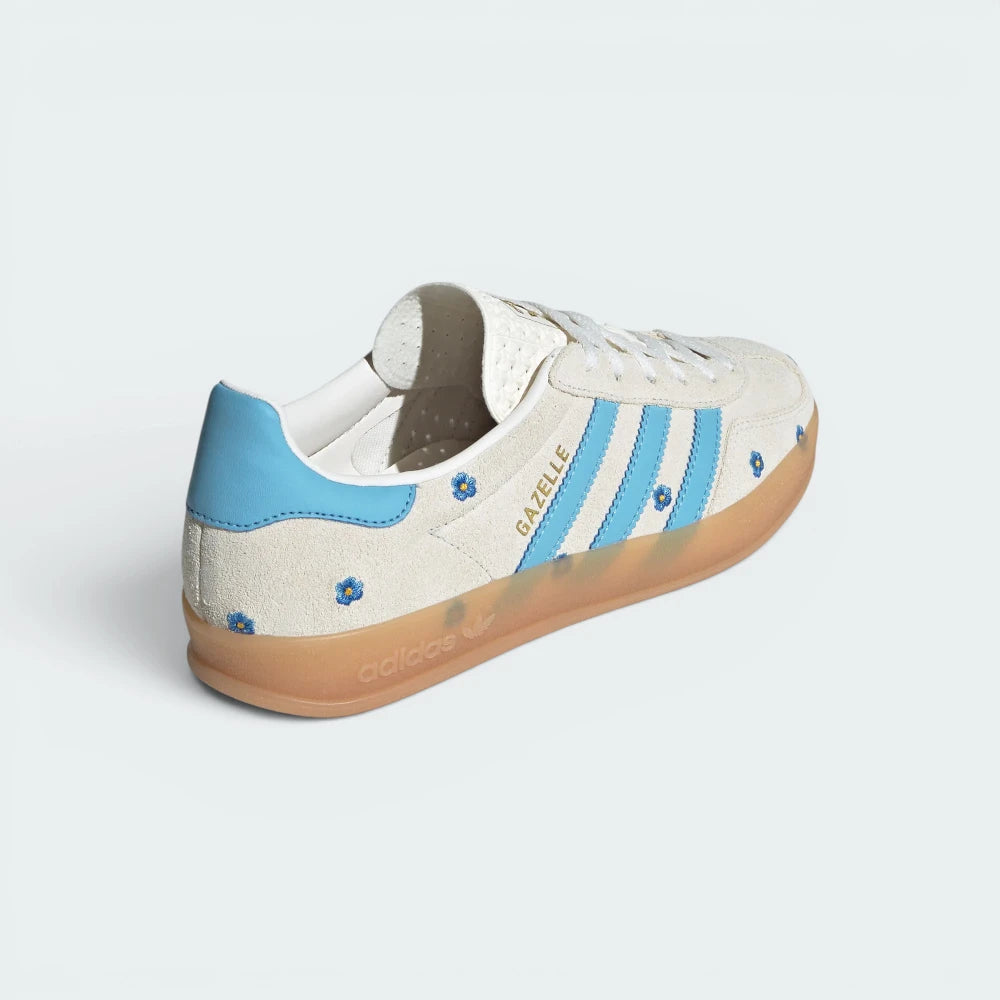 Focuses on the contoured shape of the blue leather heel counter and the clean finish of the wrapping translucent rubber sole wall.