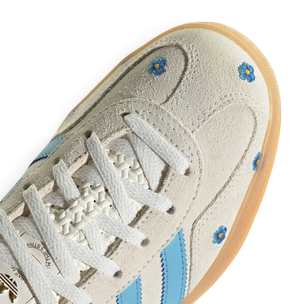 Details the premium dual-stitching lines crossing the velvety suede toe box and the precision lace eyelet configuration.
