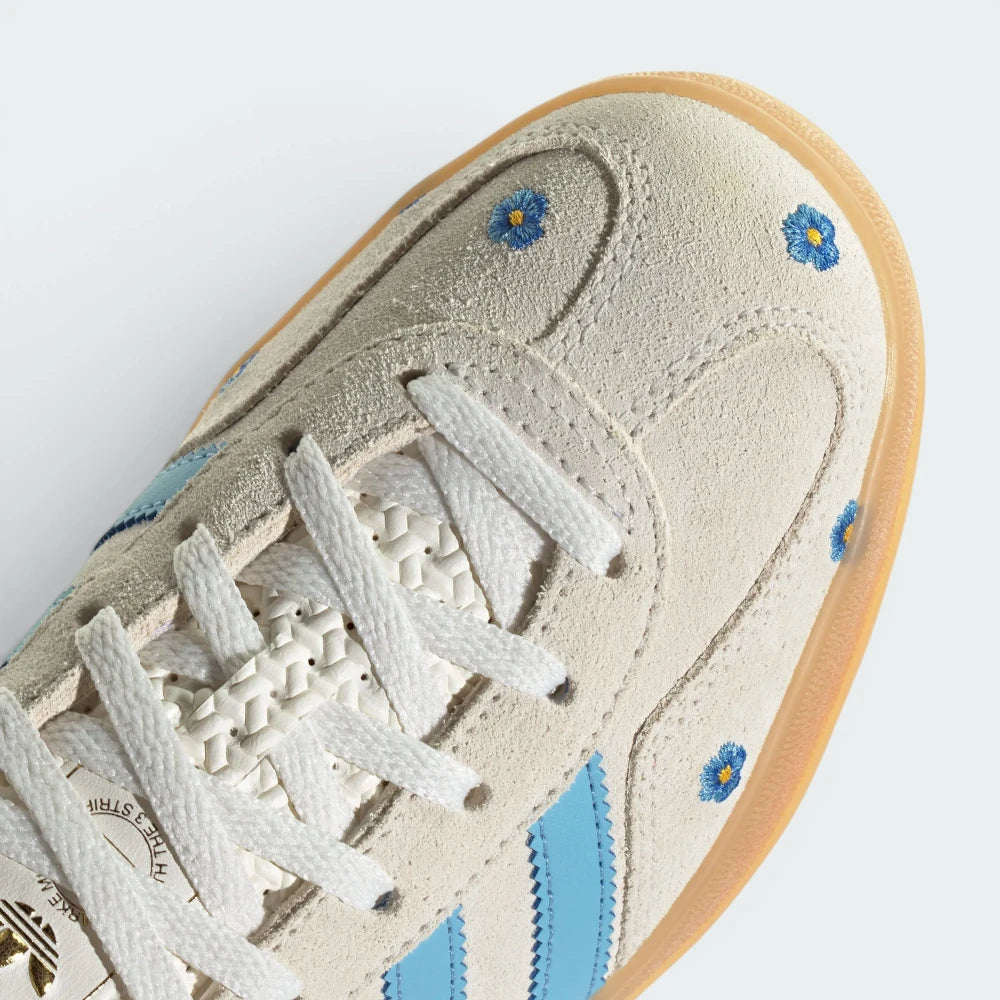 Details the premium dual-stitching lines crossing the velvety suede toe box and the precision lace eyelet configuration.