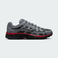 Nike P-6000 SE men's trainers in black and anthracite grey with white accents, side profile showing layered mesh and synthetic/leather overlays.