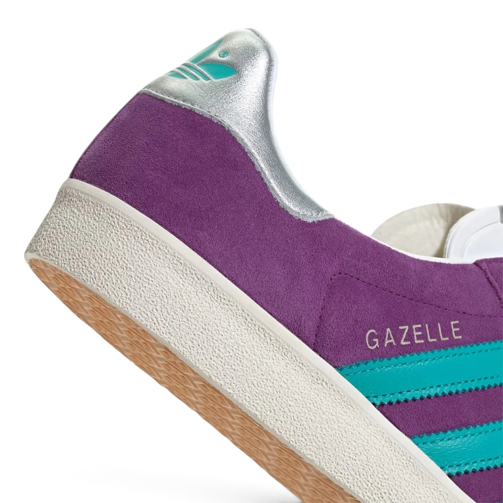 Highlights the "unreal" clean finish where the vintage-style white rubber sidewalls bond securely to the rich purple nubuck upper.