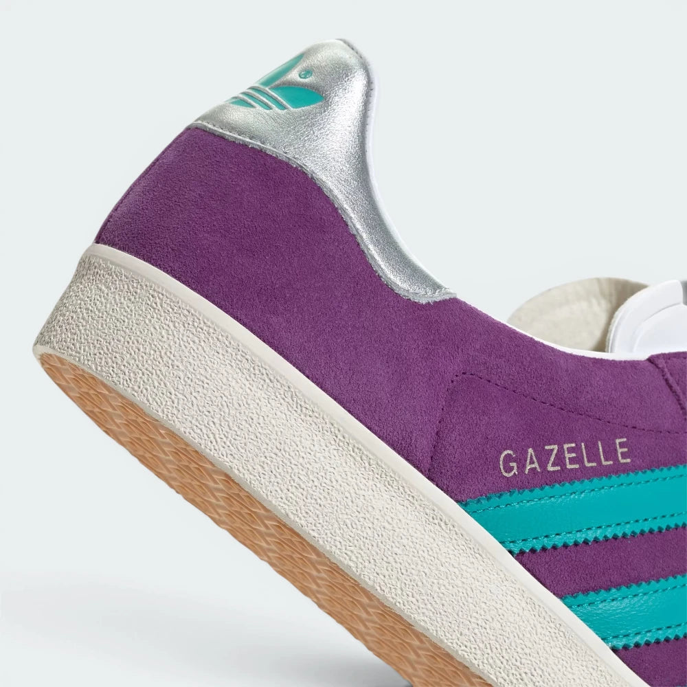 Highlights the "unreal" clean finish where the vintage-style white rubber sidewalls bond securely to the rich purple nubuck upper.