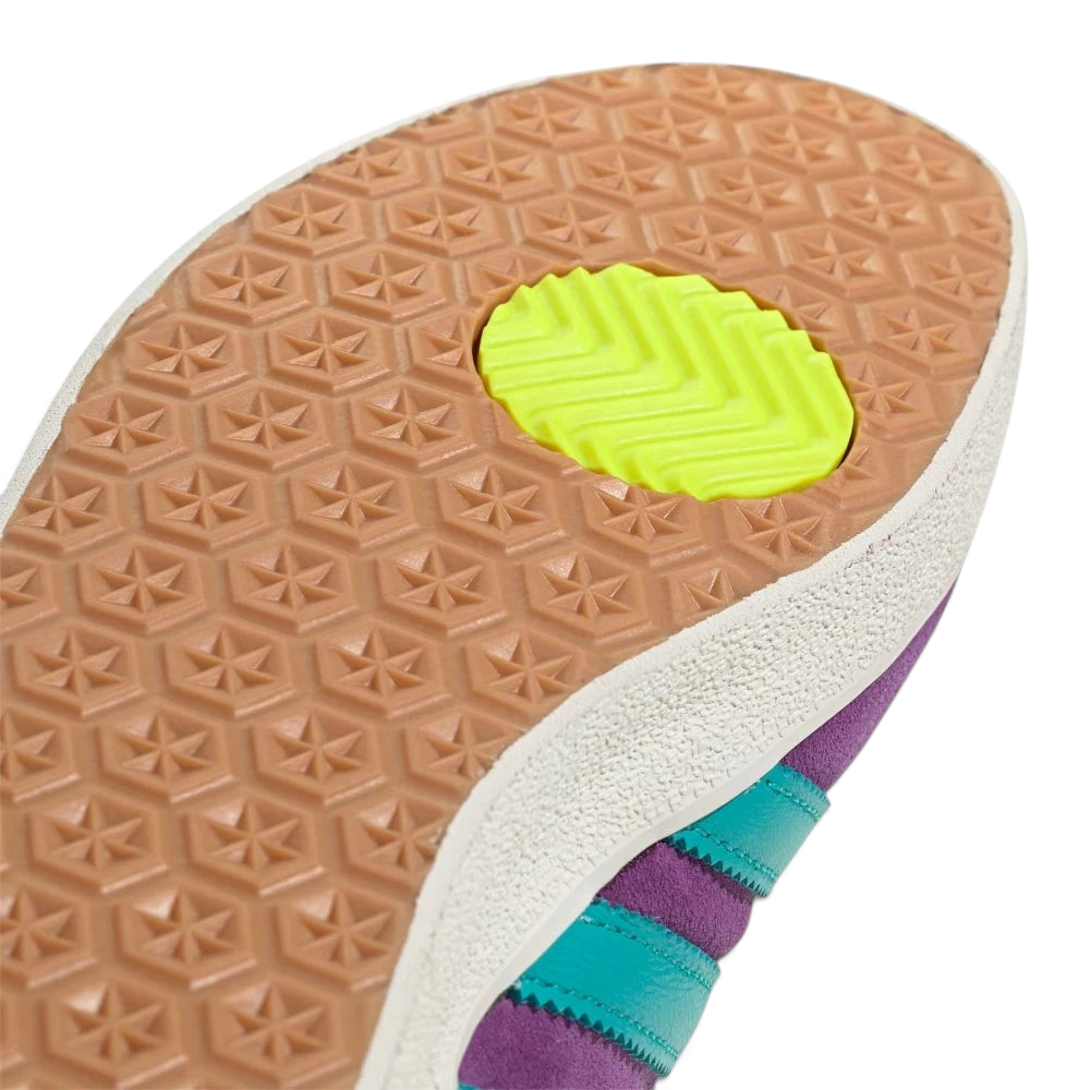 Close-up of a shoe sole with a textured pattern and a bright yellow heel counter on a white background.
