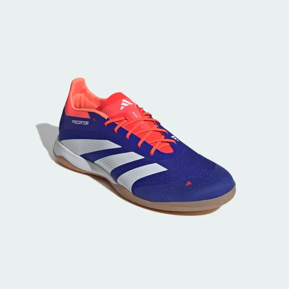 Angled shot of boots on the side, showcasing the sleek, low-to-the-ground silhouette and the vibrant blue and red colourway.