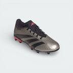 Angled shot of the boots on the side, showcasing the metallic platinum finish and the aggressive, aerodynamic design of the Predator silhouette.