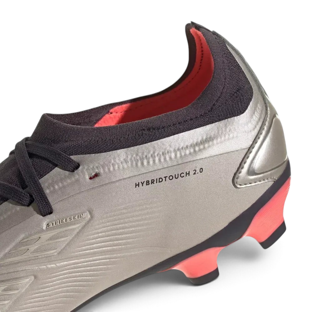Detailed zoom on the edge of the outsole and midsole area, highlighting the metallic finish and the durable construction of the multi-ground studs.