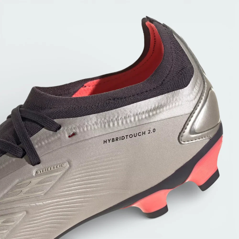 Detailed zoom on the edge of the outsole and midsole area, highlighting the metallic finish and the durable construction of the multi-ground studs.