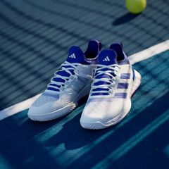 Angled shot of both Ubersonic 4.1 shoes, showcasing the aerodynamic silhouette and the vibrant purple and blue contrast detailing.