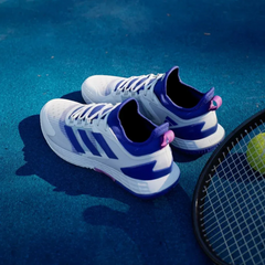 Top-down view of the tennis shoes, highlighting the breathable white mesh, integrated lacing system, and the sock-like collar.
