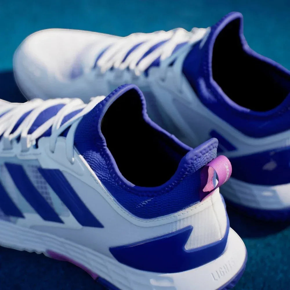 Rear view focusing on the external heel clip in Lucid Blue and the structured support for stabilizing lateral movements.