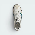 Focuses on the tidy locked-in lace closure layout, the clean alignment of the soft white tongue, and the iconic symmetrical Wonder White toe guard paneling covering the front box.