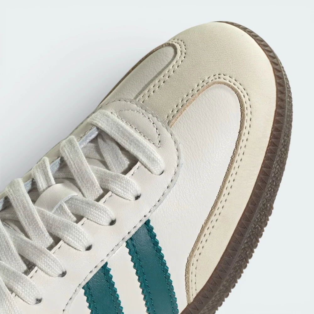Details the premium dual-stitching lines crossing the velvety suede toe box and the precision lace eyelet configuration.