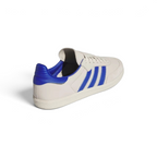 Focuses on the distinctive unstitched, floating design of the rear heel tab and the clean finish of the low-profile rubber sole.
