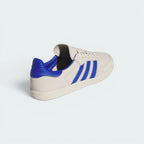 Focuses on the distinctive unstitched, floating design of the rear heel tab and the clean finish of the low-profile rubber sole.