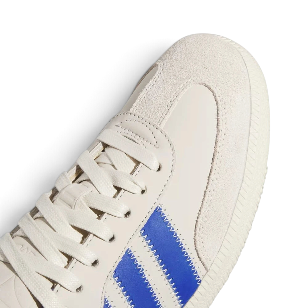 Details the intricate artisan zigzag stitching lines tracing the premium suede toe guard and the precision lace configuration.