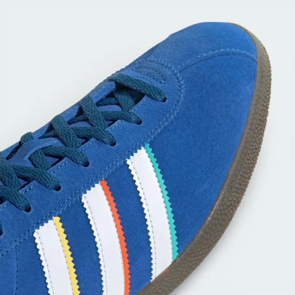Close-up of the toe box, highlighting the premium suede grain and the crisp lacing system.