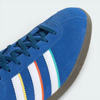 Close-up of the toe box, highlighting the premium suede grain and the crisp lacing system.