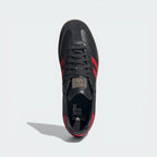 Looking down at the carbon grey lacing system and the blue Trefoil logo branding on the tongue.
