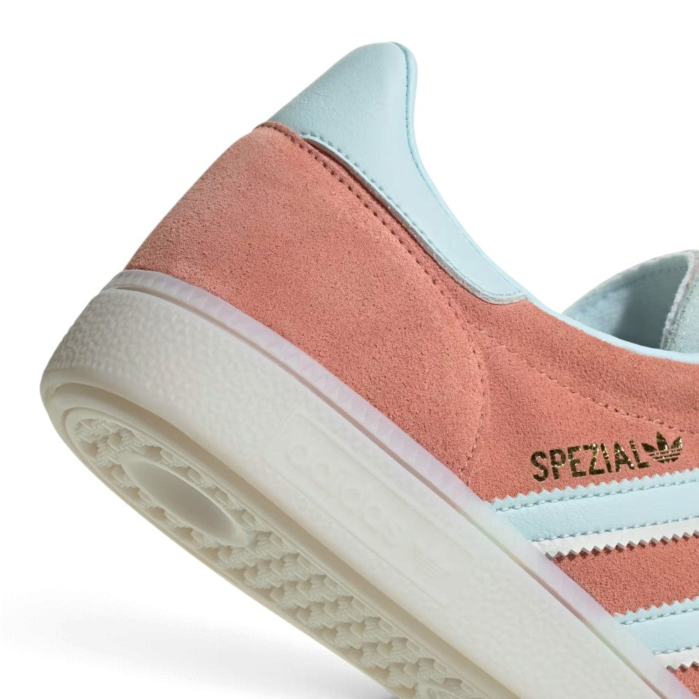 Zoom Looking at the Outsole and Midsole: Detailed close-up angle capturing the textured sidewall profile of the rubber midsole meeting the branded gold foil quarter panel.   