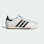 The Core White K 74, highlighting the clean black 3-Stripes and the slim, low-profile athletic silhouette.