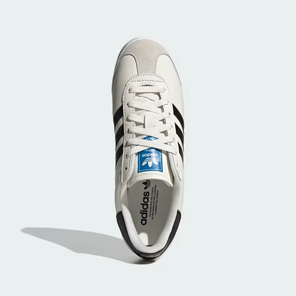Looking down at the white leather lacing system and the contrast Adidas branding on the tongue.