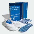 White Adidas soccer shoes with blue packaging and insoles on a white background