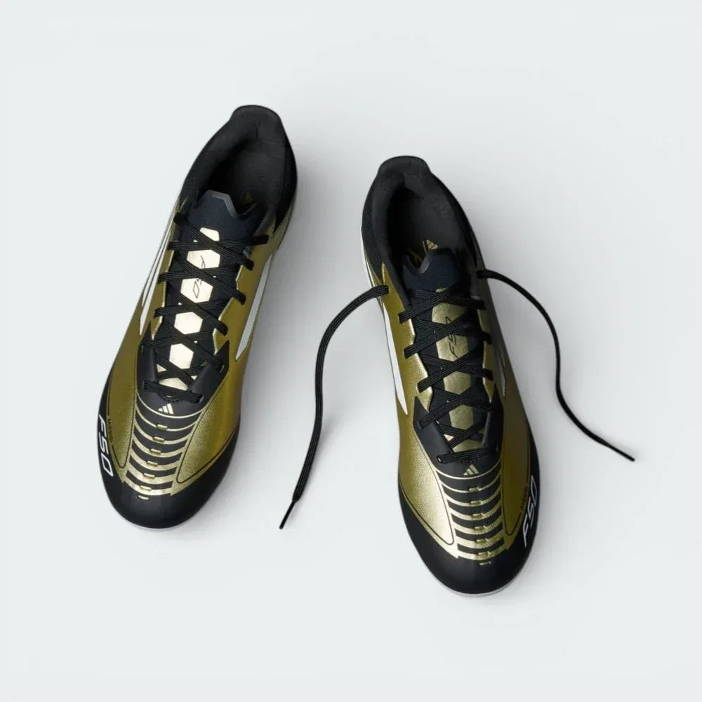 Top-down view of the gold football boots, highlighting the HybridTouch upper texture, white lacing, and the Messi branding on the tongue.