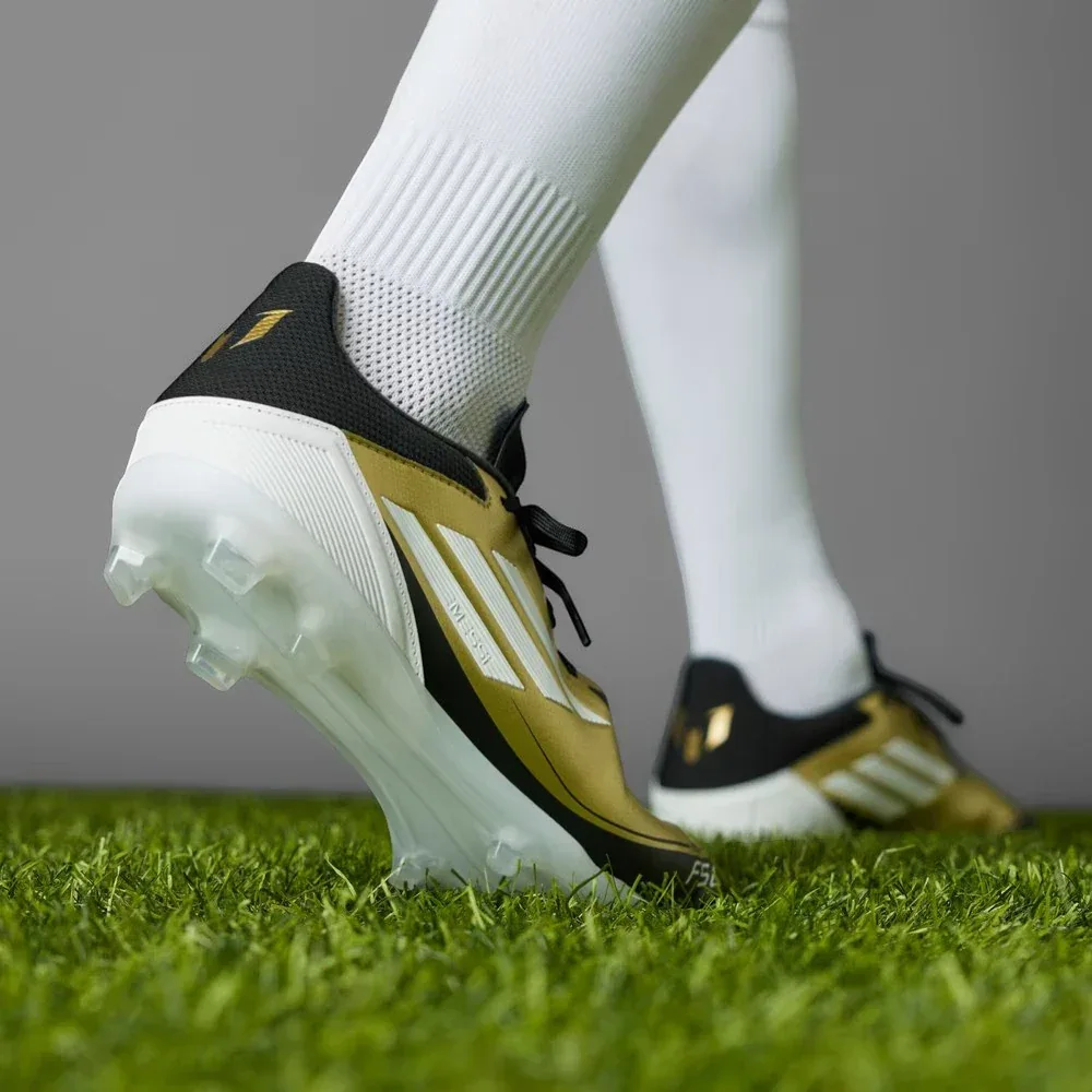Rear view focusing on the structured heel cup and the signature Messi logo detail in Core Black.