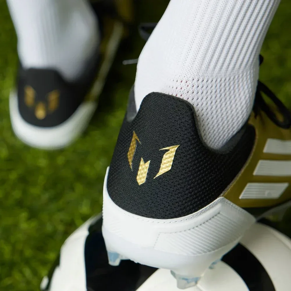 Rear view focusing on the structured heel cup and the signature Messi logo detail in Core Black.