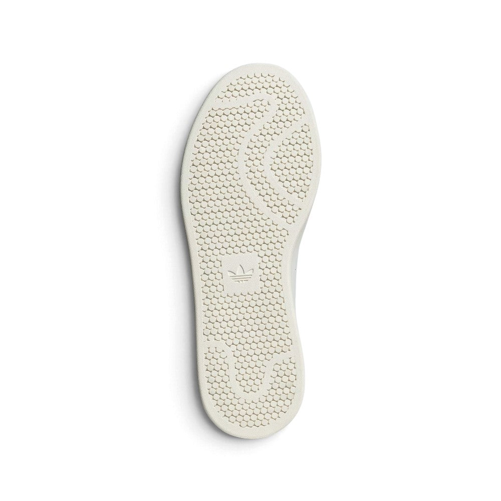 Outsole View: Bottom profile of the shoe displaying the off-white rubber cupsole featuring circular pivot dots and embossed adidas Trefoil branding at the heel.