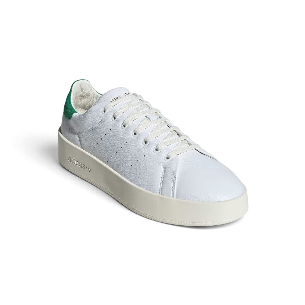 Three-Quarter Forward Angle: Three-quarter forward angle showcasing the sneakers side by side, emphasizing the clean white leather toe boxes and green suede heel counters.