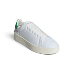 Three-Quarter Forward Angle: Three-quarter forward angle showcasing the sneakers side by side, emphasizing the clean white leather toe boxes and green suede heel counters.