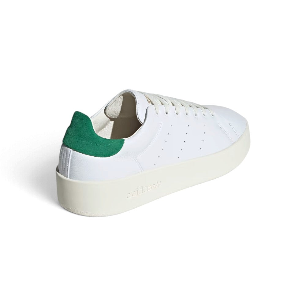 Rear View Looking at the Heel: Rear view of the sneakers emphasizing the green heel tabs, structured heel counters, and debossed branding along the sidewall of the chunky off-white midsole.