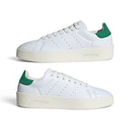 A pair of white Adidas Stan Smith Classic Low sneakers with green heel tabs and off-white platform soles, shown from the side on a clean white background.