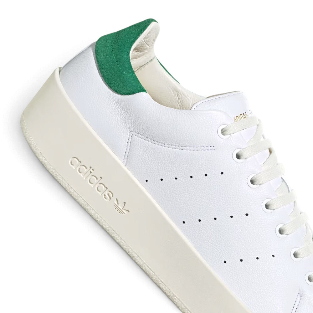 Heel and Midsole Zoom: Close-up shot of the green heel tab and gold metallic tongue print, showcasing the high-grade material finish and debossed midsole logo.