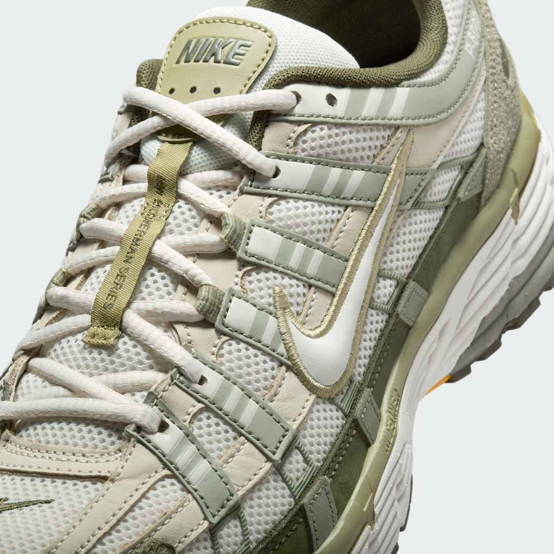 Close-up zoom on the front of the Nike P-6000 men's trainers, showing the intricate mesh base, layered overlays, and lacing system.