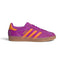 Side Profile Image: Studio lateral shot of the adidas Gazelle Indoor in Purple Burst and Eqt Orange, highlighting the rich purple velvet upper, contrasting orange serrated three stripes, gold foil Gazelle lettering, and translucent gum rubber midsole and outsole.   