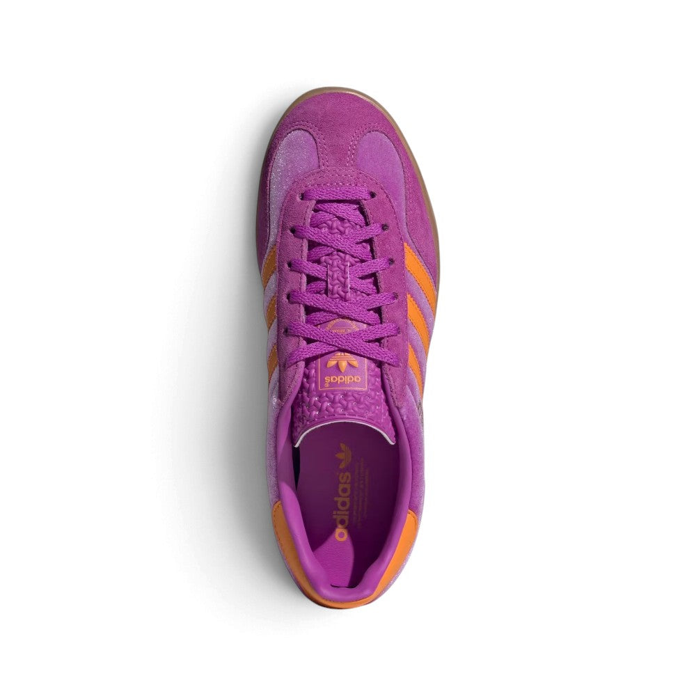 Top-Down View of Pair/Item: Overhead view looking down at the laced purple shoes, displaying the textured patterned tongue with the pink and orange Trefoil badge and the branded leather insole.   