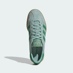 Looking down at the green suede lacing system and the tonal branding on the tongue.