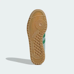 The classic hexagonal traction pattern on the honey-coloured gum rubber sole.