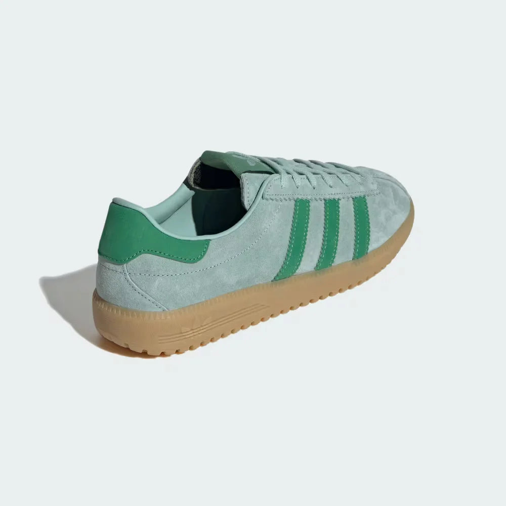 Focusing on the Preloved Green heel tab and the seamless transition into the gum outsole.