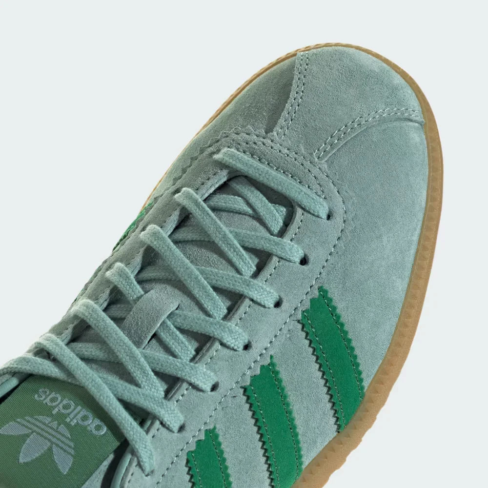 A close-up of the fine suede grain and the precision stitching around the toe box.