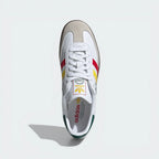 White Adidas sneaker with colorful accents on a light gray background